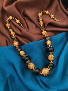 gold polish balls with black beads mala