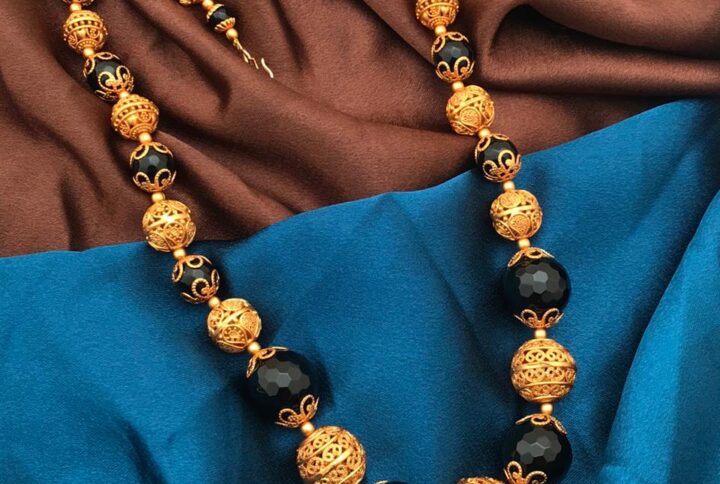 gold polish balls with black beads mala