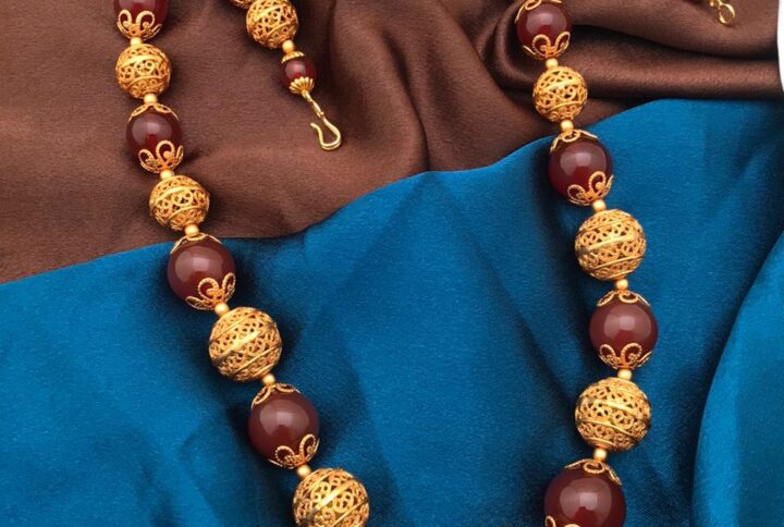 gold polish balls with brown beads mala
