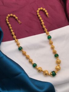 gold polish balls with green beads