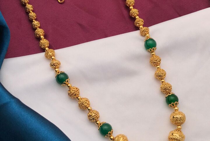 gold polish balls with green beads