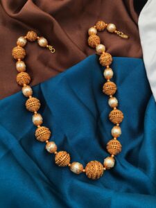 gold polish balls with white beads mala